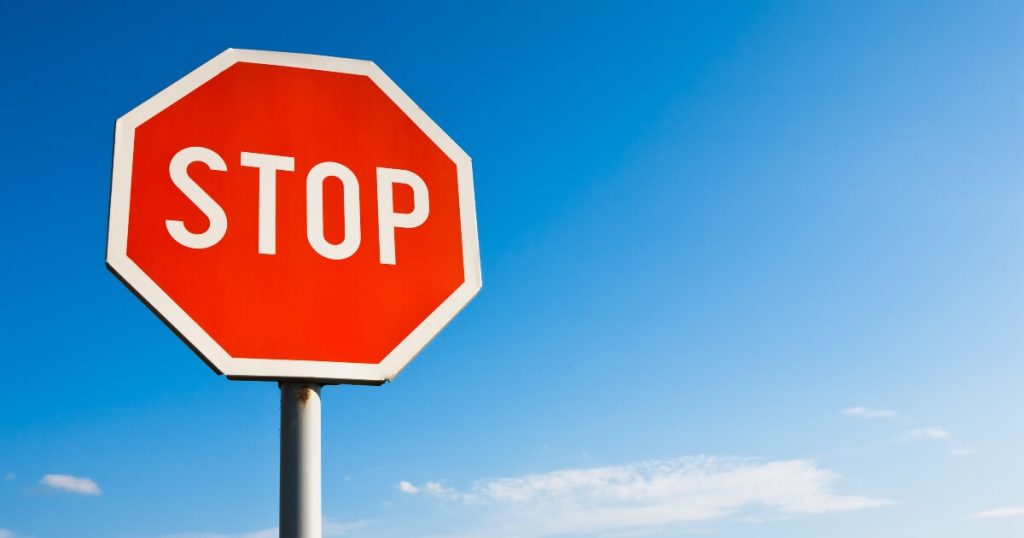 Current image: image of a stop sign against a bright blue sky