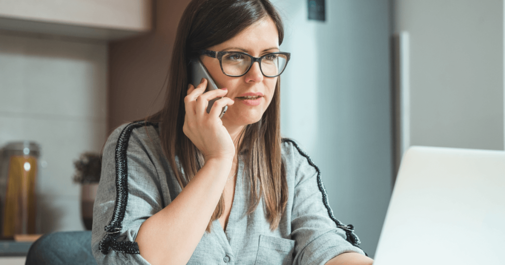 Current image: woman making phone call at desk